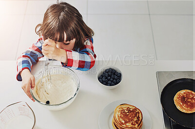 Buy stock photo Boy, cooking and pancakes for breakfast, food and sweet for family in home kitchen. Whisk, baking and child or chef person for nutrition, independence and blueberries for vegan health and vitamin c