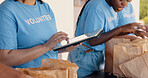 People volunteering, tablet and food donation in community service, poverty support and NGO checklist. Nonprofit, hands or group packaging groceries, planning package or helping for charity project