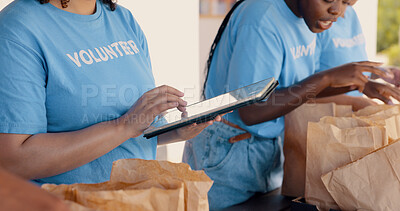 People volunteering, tablet and food donation in community service, poverty support and NGO checklist. Nonprofit, hands or group packaging groceries, planning package or helping for charity project