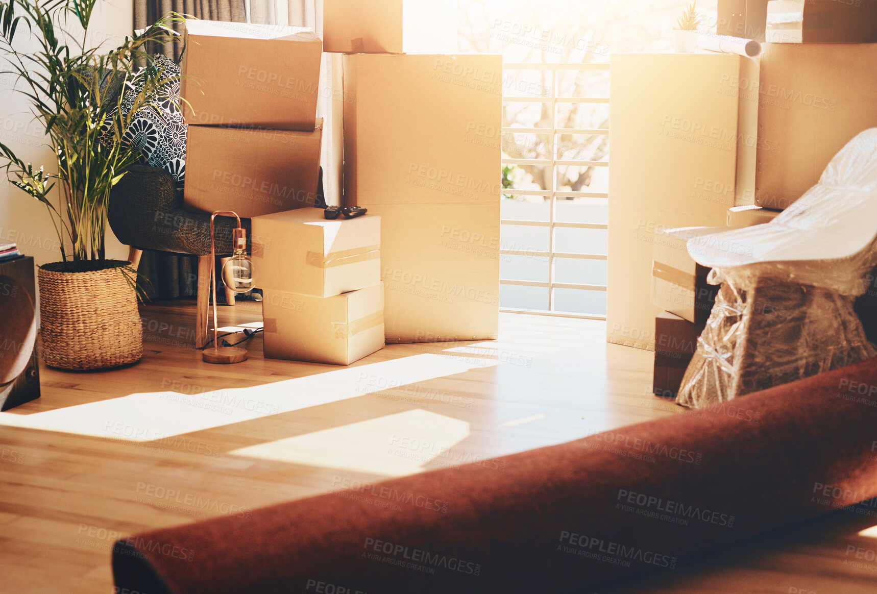 Buy stock photo Boxes, interior and furniture in new home, real estate and property development in lounge. Empty, cardboard and ergonomics with moving sale, unpacking and beginning with growth and residential loan