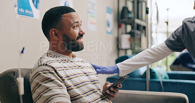 Woman, nurse and talking with patient for checkup, healthcare or appointment in lounge at hospital. Happy female person or scrub consulting man or client in waiting room for drip or therapy at clinic