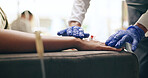 Nurse, needle and hands with medical gloves at a hospital with vaccine and healthcare IV infusion. Medicine, clinic and support with patient and doctor helping with blood sample for treatment,IV Bar