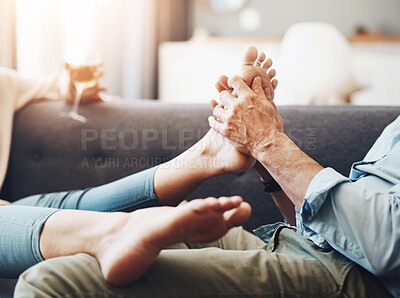 Buy stock photo Couple, couch and hands for foot massage in home with partner, stress relax or health benefits with love Senior people, bonding and support for feet in house, retirement circulation for wellness