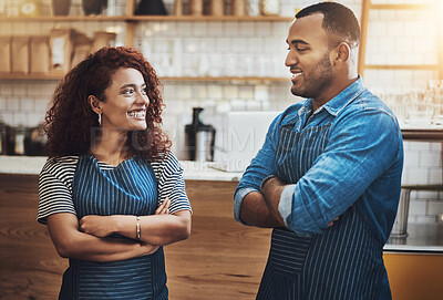 Buy stock photo Cropped shot of an affectionate young couple standing with their arms crossed in their coffee shop