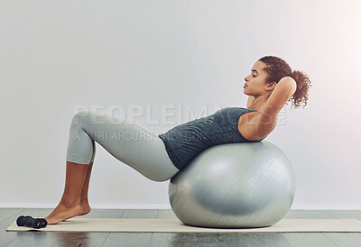 Buy stock photo Ball, fitness and sit up with woman in studio on white background for core strength, wellness or workout. Exercise, training and profile of person with equipment for balance, health or stability