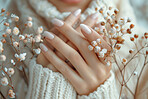 Woman, hands and flowers in closeup with nature for art, beauty and natural in winter. Female person and fingers with floral or plant in zoom, sustainable fashion or eco friendly and accountability