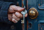 Hand, door and elderly person with key for safety, security or property investment in retirement. Real estate, mortgage or senior citizen at house with lock for privacy, independence or home access.