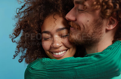 Love, hug and smile with couple in blue background with mockup, affection and romance in studio. Interracial people, man and woman loving by bonding, trust or safe and relationship with commitment