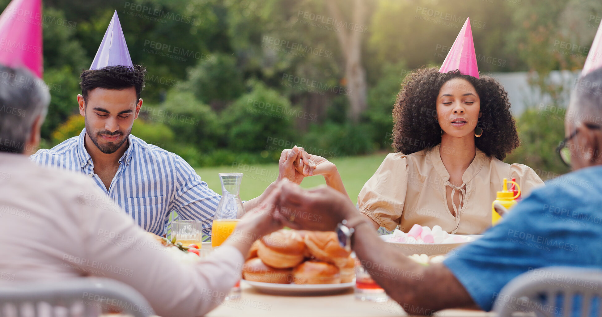 Buy stock photo People, hand holding and pray at table for food as family or meal gratitude or religion, support or thankful. Men, women and outdoor gathering for god at social event or holy grace, together or faith