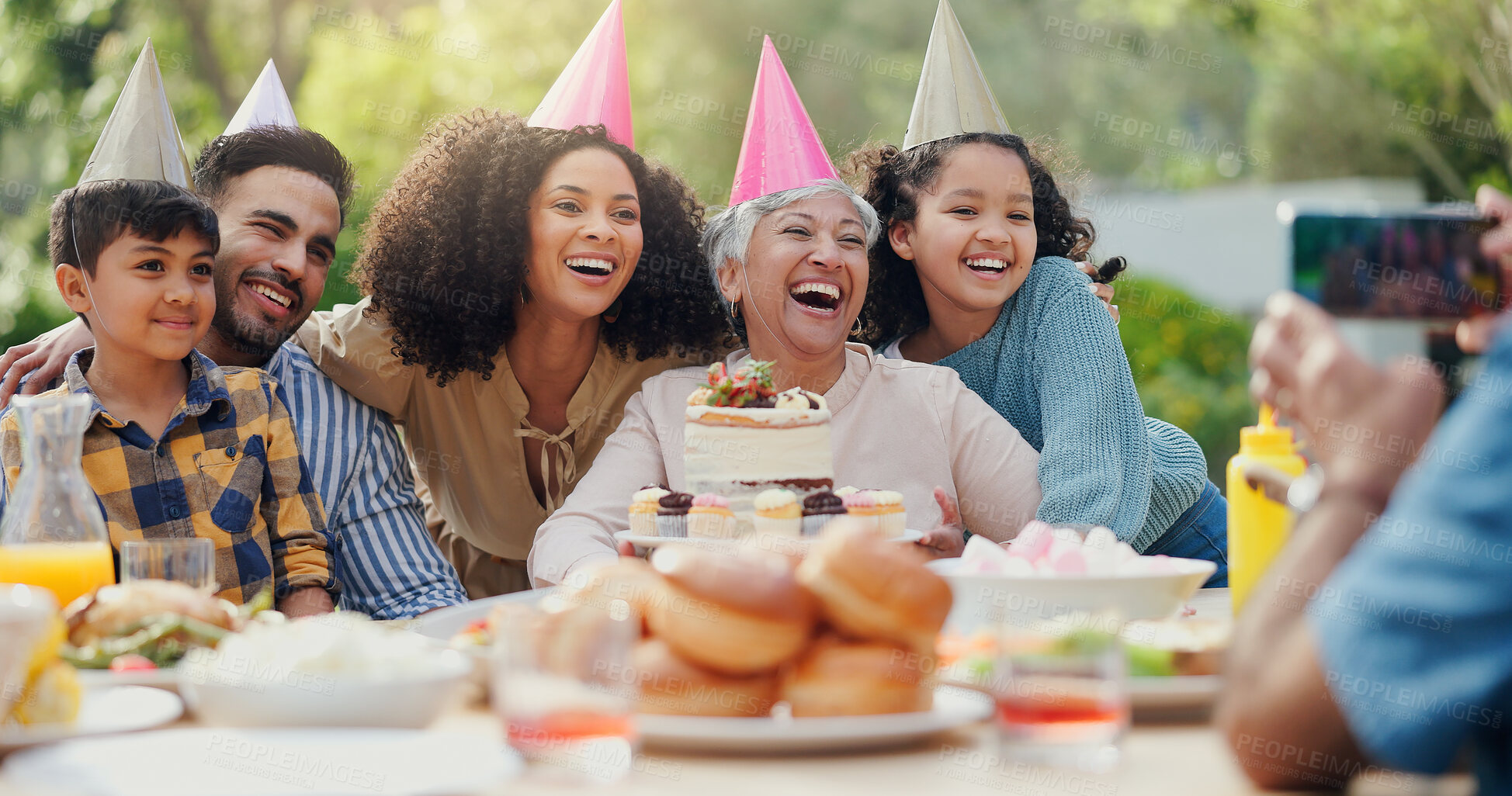 Buy stock photo Family, birthday party and people with phone for photo in garden with cake, happy and love. Grandmother, parents and children with smartphone for memory, dessert and home in backyard on social media