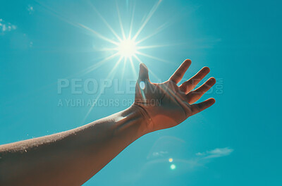 Faith, hand and stretch with sun for religion, hope and spiritual balance with blue sky background. Person, open palm and heaven with sunshine for prayer, blessing and connection with god in nature