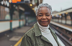 Black woman, portrait and train station platform or travel commute in city, infrastructure or subway. Female person, mature and public transportation as tourist in United States, explore or adventure