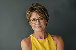 Glasses, portrait and mature executive assistant in studio on gray background for administration. Confident, corporate and face with professional business woman at work for company mission or vision