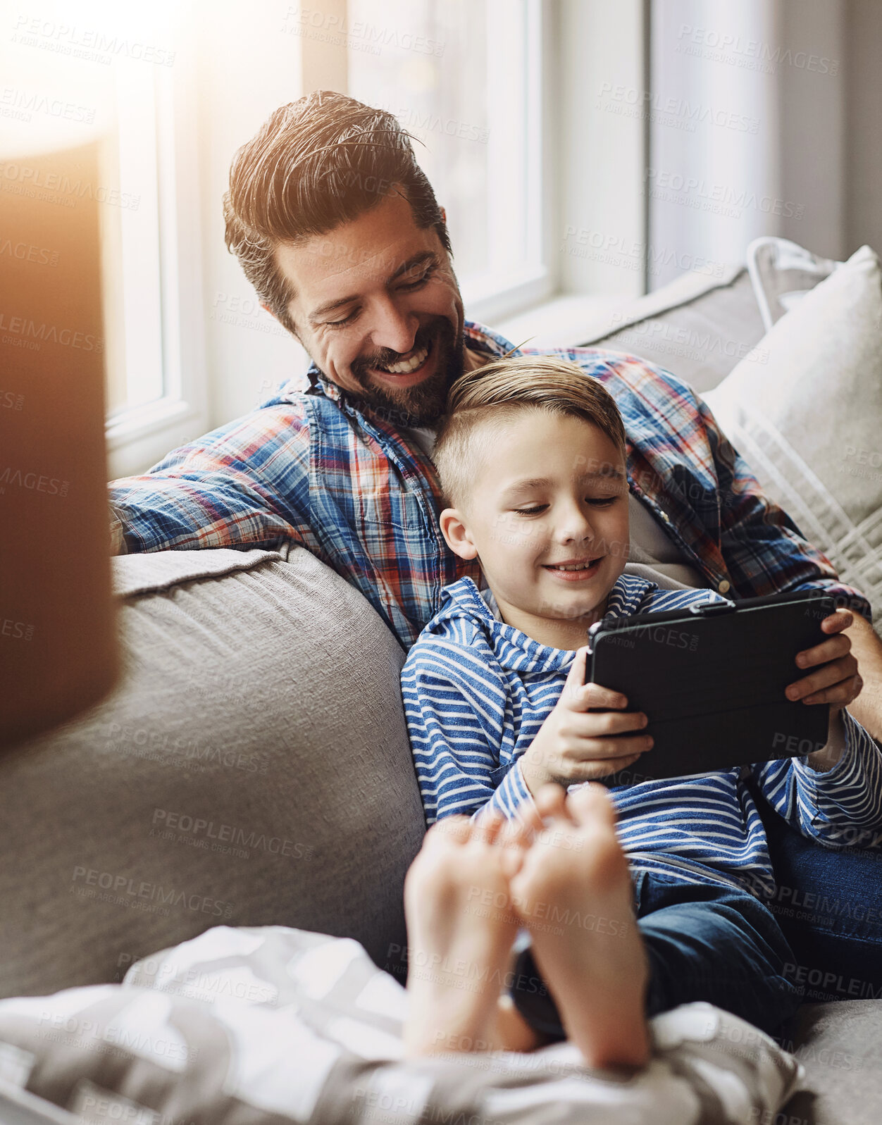 Buy stock photo Father, boy and tablet on sofa with internet for educational gaming, movie bonding and online tv show. Family, man and son with digital tech on couch in living room for relax, streaming and happy