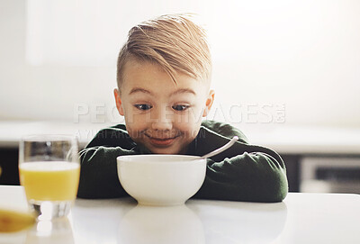 Buy stock photo Cropped shot of an adorable little boy having breakfast while sitting in the kitchen