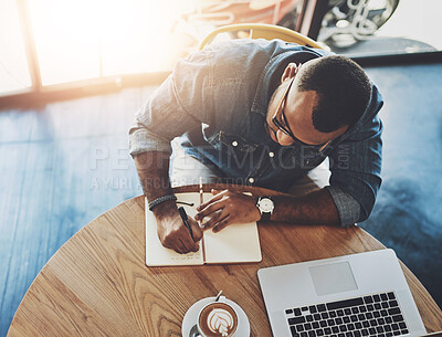 Buy stock photo Remote work, black man and writing in coffee shop for plan, strategy and schedule at laptop in cafe. Male journalist, latte and computer in restaurant with notebook, idea or brainstorming for article