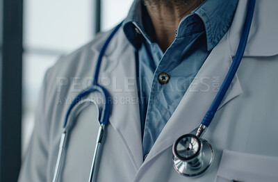Healthcare, coat and doctor with stethoscope in clinic for wellness appointment, trust or surgery. Closeup, medical worker or cardiology with tools for checkup, consulting or professional in hospital