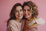 Mom, daughter and happy on portrait in studio on pink background with hug for mothers day, appreciation and support. Parent, child and smile with care, love and affection with confidence as family