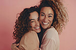 Smile, hug and portrait of lesbian couple in studio with love, care and lgbtq relationship. Happy, happy and queer women embracing for bonding, pride and support together isolated by pink background.