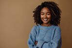 Portrait, business and black woman with arms crossed in studio isolated on brown background mockup space. Face, happy professional and confident creative entrepreneur or designer at startup in Kenya