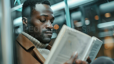 Black man, train and reading with book for knowledge, story or literature in travel to subway station. African or male person with novel for information or learning language in commute or immigration
