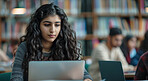 Laptop, reading and woman in college library studying for exam, assignment or test online. Education, technology and female student working on university project with computer in classroom at campus.