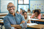 Students, classroom and portrait of teacher with arms crossed for education, lesson and child development. Kids, man and happy with pride at high school for leadership, support and career in teaching