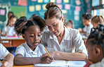 Girl, student and teacher help with writing notes in school for education, learning and knowledge. Assistance, tutor and creative kid in classroom to study for exam, test or lesson for development