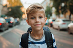 School, children and portrait with boy learner outdoor on street for education or learning. Backpack, face and student with happy young kid as pupil at academy for child development or scholarship