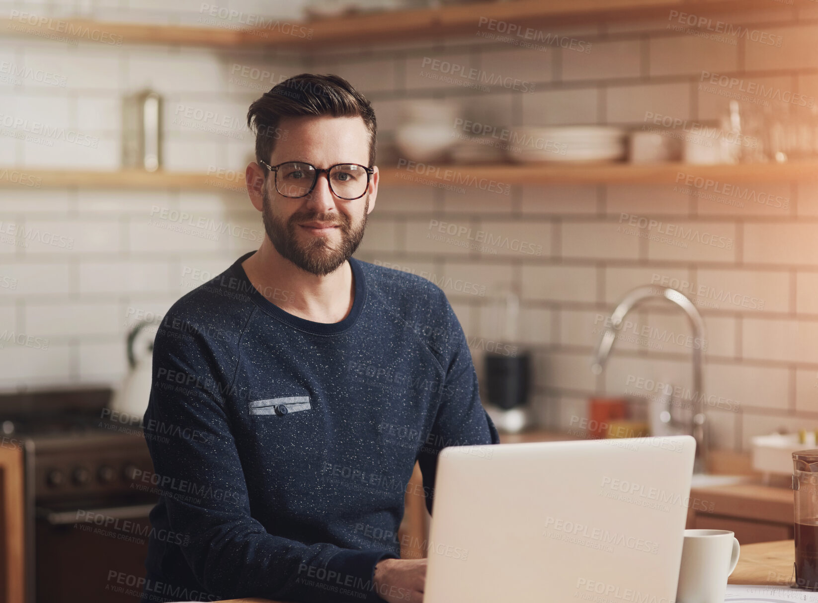 Buy stock photo Laptop, portrait and remote work with man in kitchen of home to research information for startup. Computer, glasses and small business with freelance employee in apartment for online administration