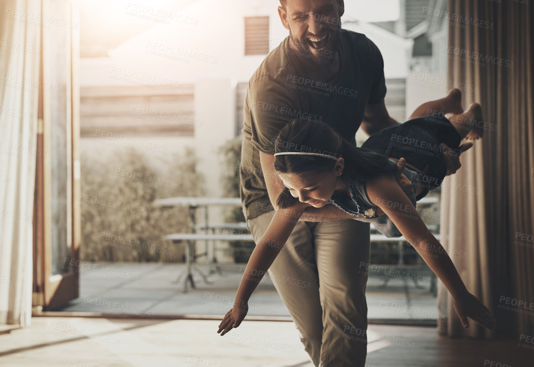 Buy stock photo Funny, dad and kid play airplane game, fly and family bonding together in living room. Laughing, girl and excited father carrying child with energy for support, freedom and love of parent in home