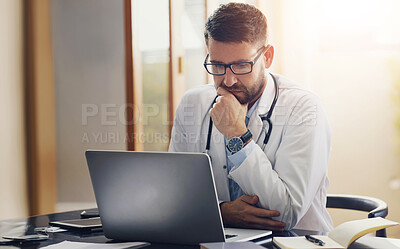 Buy stock photo Male person, doctor and laptop with thinking, ideas and planning in office as medical professional. Man, pediatrician and diagnosis, telehealth and technology for patient records, medicine or surgery