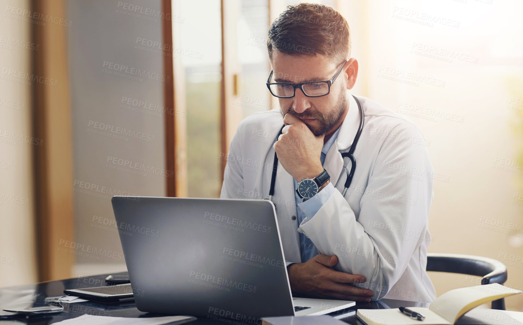 Buy stock photo Male person, doctor and laptop with thinking, ideas and planning in office as medical professional. Man, pediatrician and diagnosis, telehealth and technology for patient records, medicine or surgery