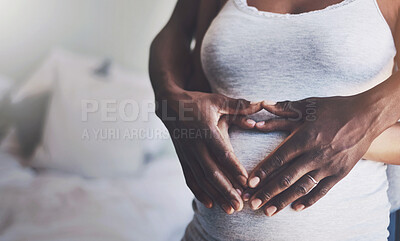 Buy stock photo Hands in heart, pregnancy and couple on stomach in bedroom for bonding, parenting and excited for baby. Family, maternity and man and pregnant woman embrace for love, affection and wellness in home