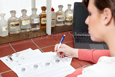 Buy stock photo Shot of a forensic scientist writing up a ballistics report 