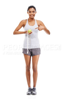 Buy stock photo Woman, lose weight and pointing to measuring tape and apple in white background or studio. Indian, model and happy with results of fitness, wellness and diet with healthy food, nutrition and fruit