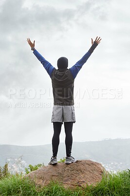 Buy stock photo Man, runner or victory on mountain peak for training adventure, exercise or workout success. Hill, fitness or back of hiker with hands up, gratitude or freedom in park to explore nature outdoors