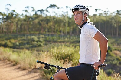 Buy stock photo Man, cyclist and thinking on mountain bicycle, training and energy for rider, cycling and sport. Outdoor, hobby and fitness in nature, trail and active for wellness, helmet and physical workout