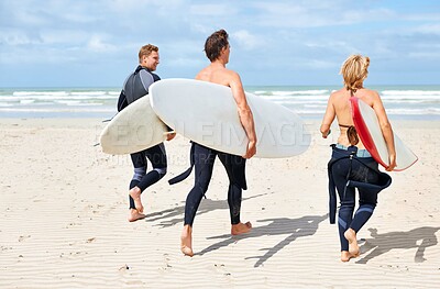 Buy stock photo Surfer friends, running and back at beach with board, training or fitness on vacation in summer. Men, woman and surfboard for wellness, health or workout by ocean, waves or freedom on holiday on sand