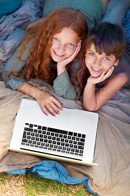 Buy stock photo Children, portrait and smile with laptop for camping in tent, streaming or online movie with aerial view in nature. Family, face and siblings or happy outdoor on grass for trip, relax and holiday