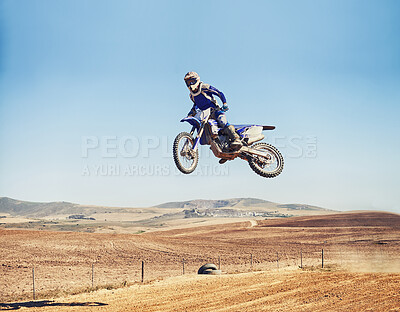 Buy stock photo Person, jump and dirt bike of professional motorcyclist in the air for trick, stunt or race on outdoor track. Expert rider on motorbike or scrambler in dunes or extreme sport with blue sky mockup