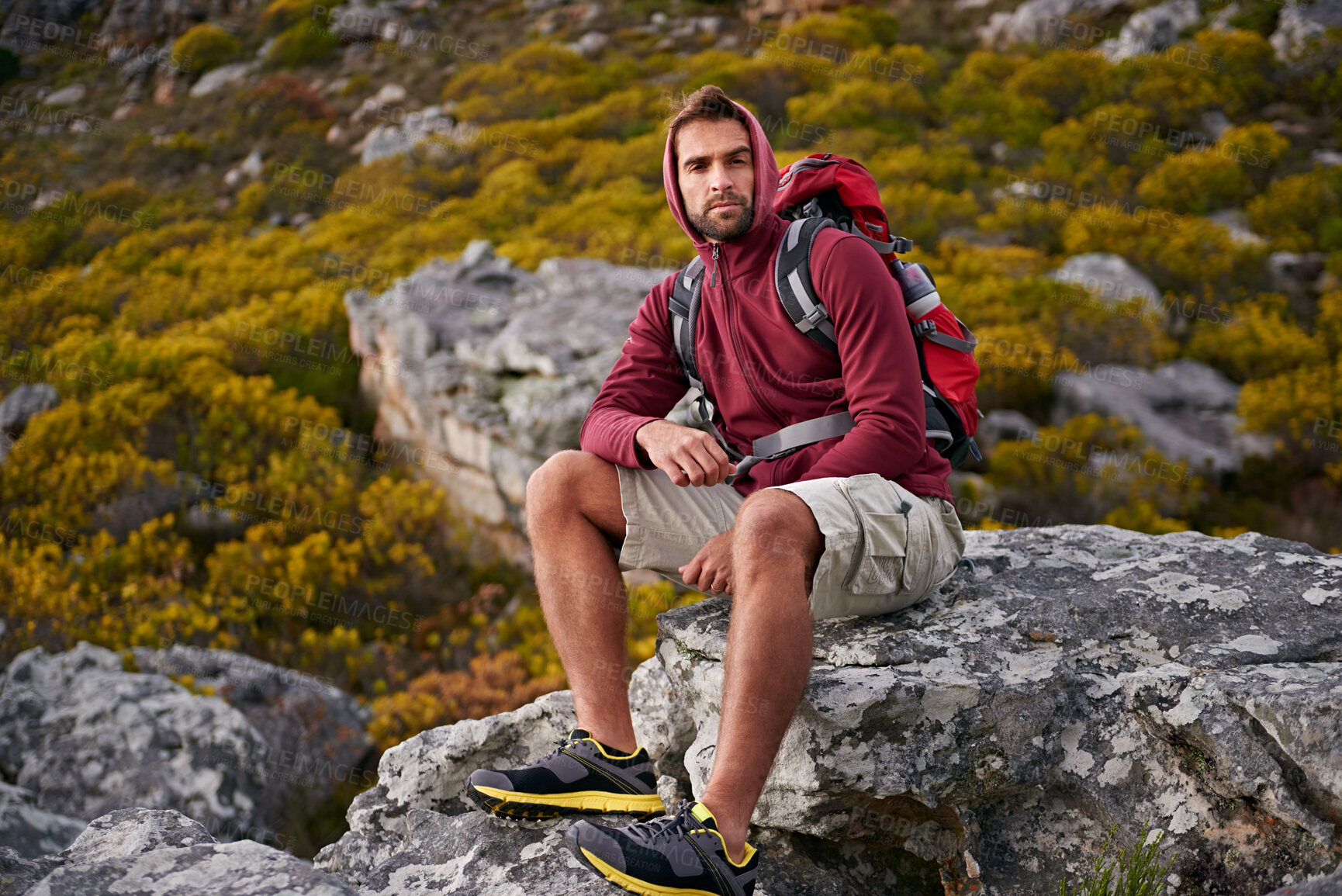 Buy stock photo Man, mountain and hiking in nature for rest and fitness for wellness and exercise for training and adventure in environment. Young person, sitting with backpack on rock for workout and trekking