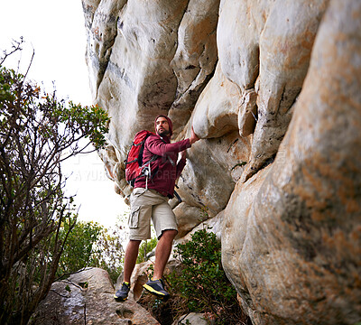 Buy stock photo Man, mountain climbing and exercise for travel outdoor, freedom and journey with adventure, focus and strong. Determination, concentration and trekking with challenge, peak and rocks on rough terrain