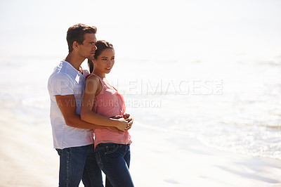 Buy stock photo Couple, beach and hug in relax with love for embrace, care or support on outdoor holiday or vacation in nature. Young man and woman enjoying weekend for bonding together by the ocean on mockup space