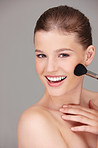 Woman, smile and portrait with makeup brush for blush skincare, dermatology and aesthetic beauty in studio. Young person or model and happy with clean face for hygiene and fresh with glowing lipstick