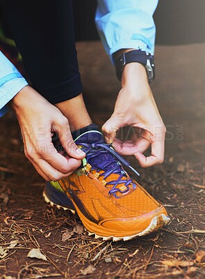 Buy stock photo Hands, runner and tie laces on ground for training, exercise or fitness in nature, morning and outdoor. Person, athlete and prepare with shoelace, sneakers or workout for health on countryside path