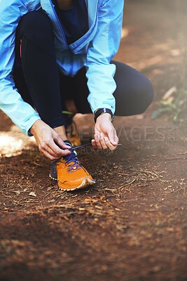 Buy stock photo Hands, runner and outdoor to tie shoelace on ground for training, exercise or fitness to start morning. Person, athlete and prepare with shoes, sneakers and workout for health on countryside path