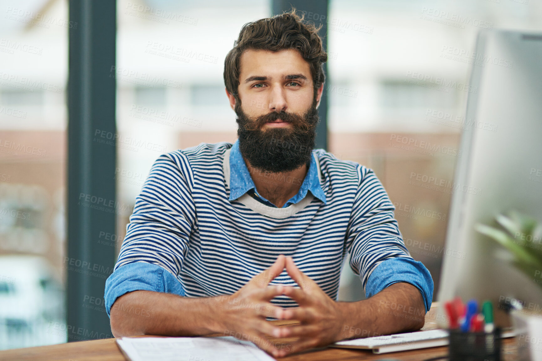 Buy stock photo Portrait, creative and confident business man at desk in office by computer in startup company. Face, serious professional or entrepreneur, designer or employee working at table in Germany for career