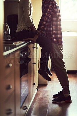 Buy stock photo Legs, love and couple in home kitchen for bonding, connection or healthy relationship in the morning. Romance, man and woman together for care, support and marriage commitment to partner in apartment