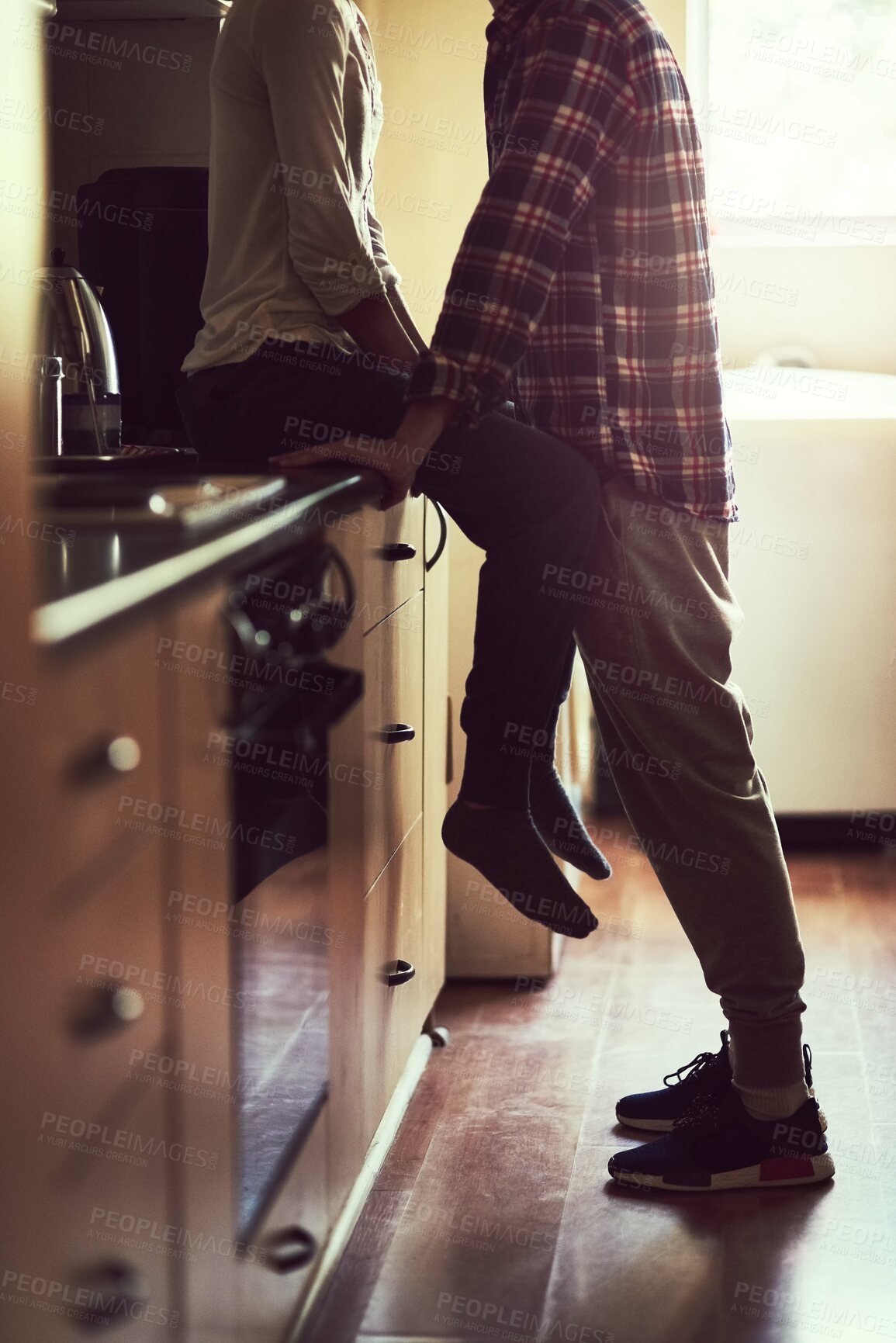 Buy stock photo Legs, love and couple in home kitchen for bonding, connection or healthy relationship in the morning. Romance, man and woman together for care, support and marriage commitment to partner in apartment